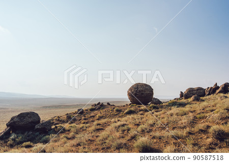 Stones on hill in meadow 90587518