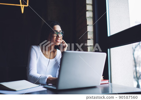 Pensive woman with laptop and smartphone Pensive woman with laptop and smartphone 90587560