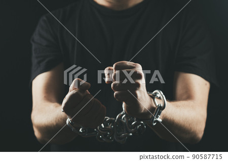 Hands chained on black background. Hands chained on black background. 90587715