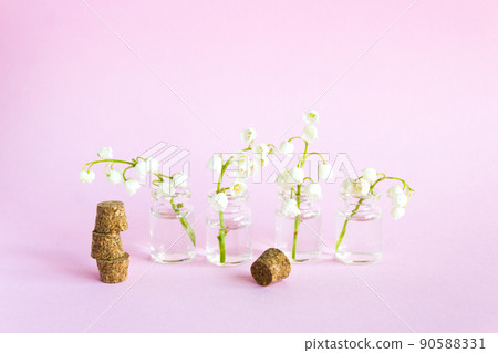 Spring flowers on white background, lily of the valley. Blooming lilies in small glass vases 90588331