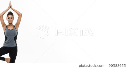 Healthy and Fitness concept - Beautiful American African lady in fitness clothing doing yoga and meditation. Isolated on white background. Healthy and Fitness concept - Beautiful American African lady in fitness clothing doing yoga and meditation. Isolated on white background. 90588655