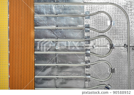 Fragment of installation of underfloor heating system with water heating. Fragment of installation of underfloor heating system with water heating. 90588932