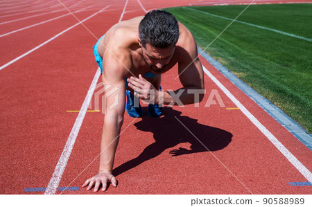 muscular guy doing push-ups standing in plank in outdoor stadium, sport muscular guy doing push-ups standing in plank in outdoor stadium, sport 90588989