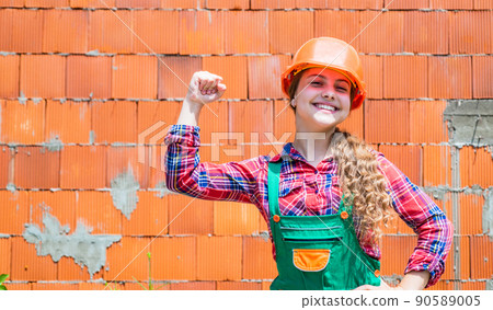 cheerful child laborer using building uniform and tool, labor day cheerful child laborer using building uniform and tool, labor day 90589005