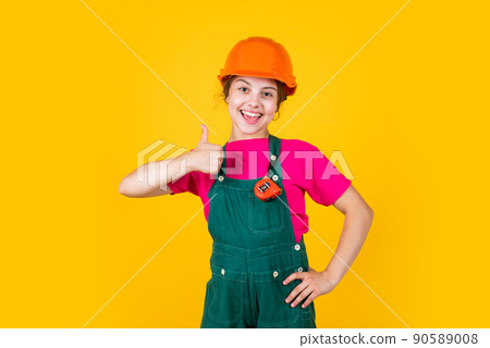 kid wear helmet on construction site. teen girl builder kid wear helmet on construction site. teen girl builder 90589008