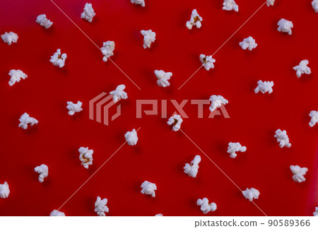 popcorn on a red background top view close-up , the concept of a cinema, watching movies . 90589366