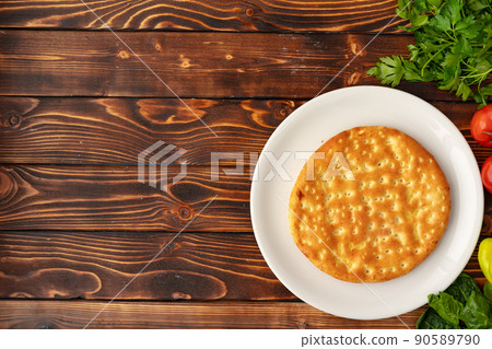 Baked homemade flatbread on wooden background close up 90589790