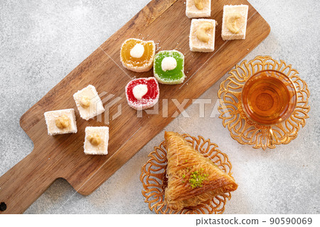 Various Turkish sweets and cup of tea on white textured background 90590069