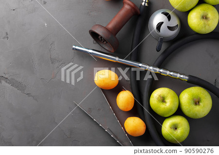 Hookah pipe and shaft with fruits on gray background Hookah pipe and shaft with fruits on gray background 90590276