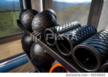Balls and foam roller sport equipment in a gym Balls and foam roller sport equipment in a gym 90590662