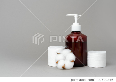 Stack of cotton discs and skicare cosmetic bottle Stack of cotton discs and skicare cosmetic bottle 90590856