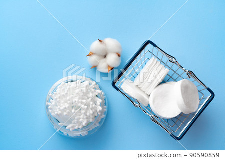 Set of cotton buds sticks on blue paper 90590859