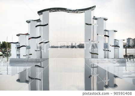 Arch for an outdoor ceremony on the shore of the lake 90591408