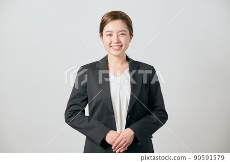 A business woman in a jacket with her hands folded in front A business woman in a jacket with her hands folded in front 90591579