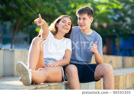 Girl prompts the boy, pointing with his hand at something Girl prompts the boy, pointing with his hand at something 90593305