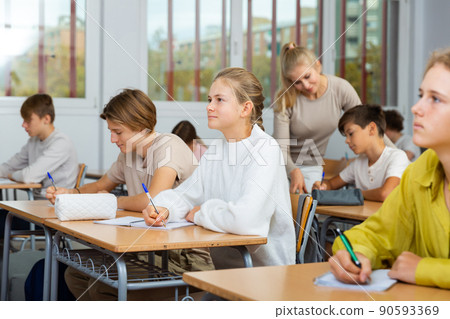 Group of school kids and teacher during lesson 90593369