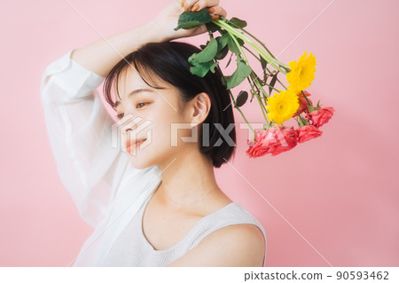 A young woman with flowers A young woman with flowers 90593462