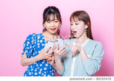 Young woman looking at a smartphone Young woman looking at a smartphone 90593476