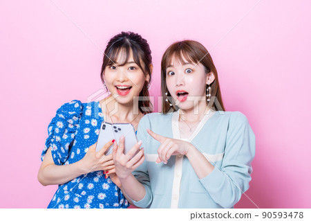 Young woman looking at a smartphone Young woman looking at a smartphone 90593478