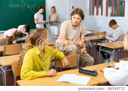 Teenagers resting and talking during recess in classroom 90593712