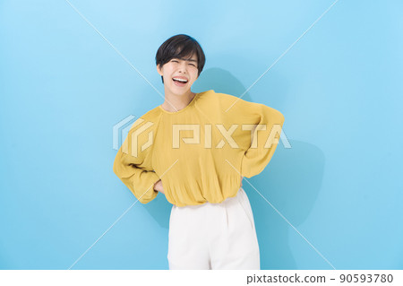 Female portrait in her 20s, light blue background Female portrait in her 20s, light blue background 90593780