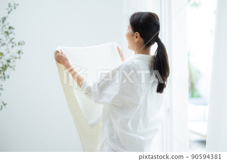 Senior women hanging out the laundry Senior women hanging out the laundry 90594381