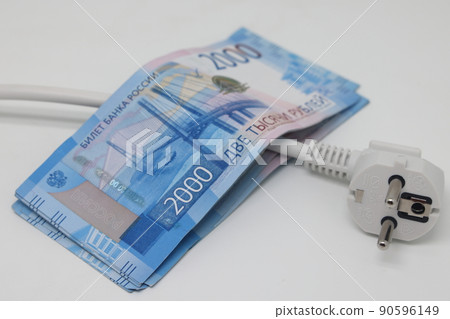 White electric cable and banknotes, expensive electricity, saving electricity. 90596149