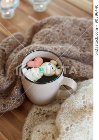 Cup of hot chocolate with figure cute marshmallows on wooden background, warm knitted plaid, cozy homely weekend, concept of seasonal winter autumn fall leasure, beverage drink 90596440