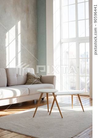 Interior design of stylish living room with modern neutral sofa, Elegant and comfortable designed living room with big corner sofa, wooden floor and big windows. Template. 90596441