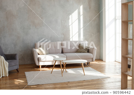 Interior design of stylish living room with modern neutral sofa, Elegant and comfortable designed living room with big corner sofa, wooden floor and big windows. Template. 90596442