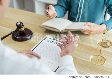Law consultancy concept A white-shirt lawyer discussing about the contract with his dealer and writing it down on his notebook. Law consultancy concept A white-shirt lawyer discussing about the contract with his dealer and writing it down on his notebook. 90596951