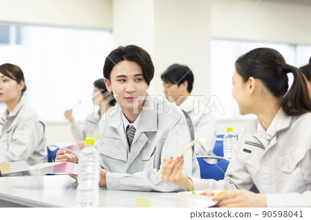 Men and women in work clothes eating lunch in the conference room Men and women in work clothes eating lunch in the conference room 90598041