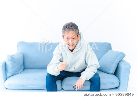 一位老人在家裡的電視上看體育節目 一位老人在家裡的電視上看體育節目 90599849
