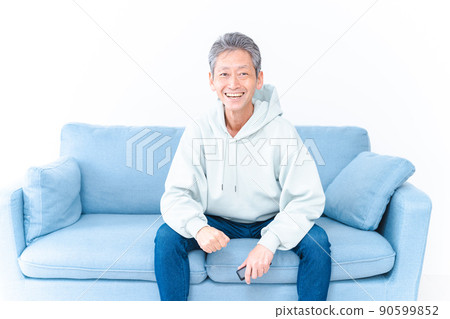An elderly man watching sports on his home TV An elderly man watching sports on his home TV 90599852