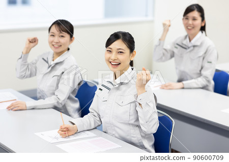 A woman in work clothes taking a seminar A woman in work clothes taking a seminar 90600709