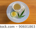 Cup of Marijuana herb and lemon hot tea on the plate. 90601863