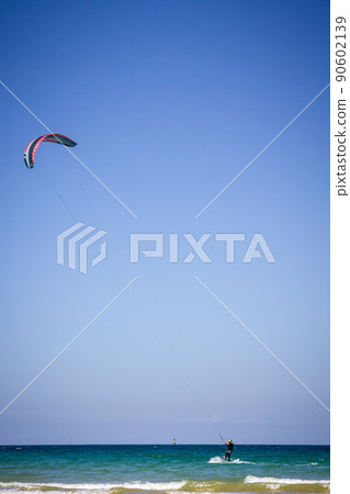 Kitesurfer on sea in Saint-Malo city, Brittany, France Kitesurfer on sea in Saint-Malo city, Brittany, France 90602139