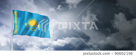 Kazakhstan flag on a cloudy sky Kazakhstan flag on a cloudy sky 90602196