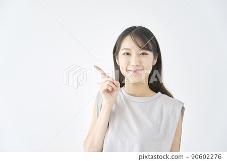 Woman pointing to the left on a white background 90602276