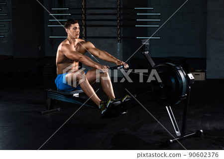Muscular man doing exercise for legs in the gym Muscular man doing exercise for legs in the gym 90602376