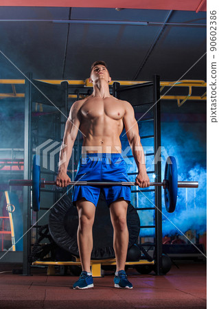 man doing exercises with barbell 90602386