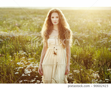 Young beautiful girl on a summer field. Beauty summertime Young beautiful girl on a summer field. Beauty summertime 90602423