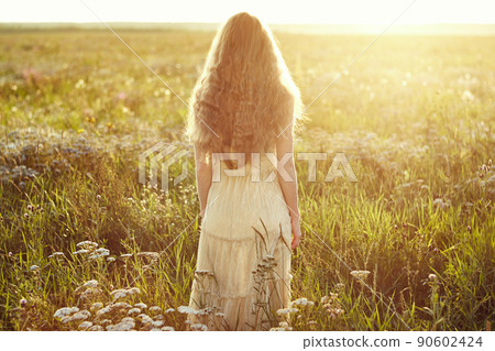 Young beautiful girl on a summer field. Beauty summertime Young beautiful girl on a summer field. Beauty summertime 90602424