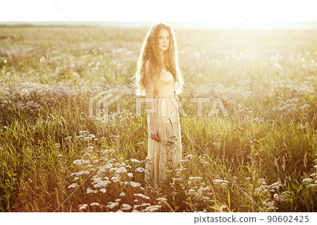 Young beautiful girl on a summer field. Beauty summertime Young beautiful girl on a summer field. Beauty summertime 90602425