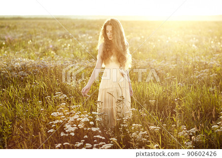 Young beautiful girl on a summer field. Beauty summertime Young beautiful girl on a summer field. Beauty summertime 90602426
