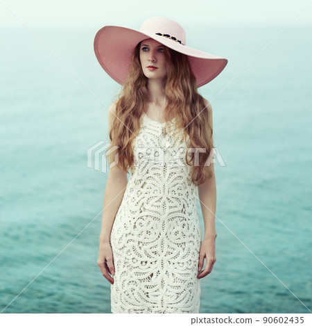 Beautiful woman in hat on the sea Beautiful woman in hat on the sea 90602435