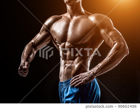 Muscular and fit young bodybuilder fitness male model posing ove Muscular and fit young bodybuilder fitness male model posing ove 90602486