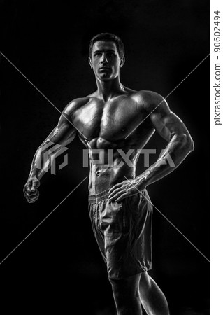 Muscular and fit young bodybuilder fitness male model posing ove Muscular and fit young bodybuilder fitness male model posing ove 90602494