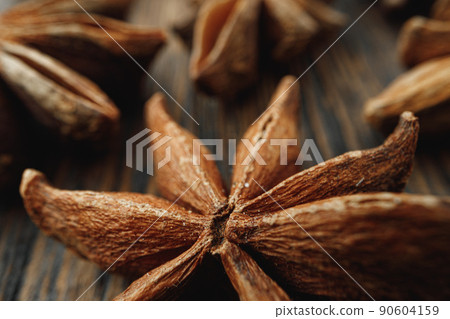 Macro photo of anise stars on wooden background 90604159
