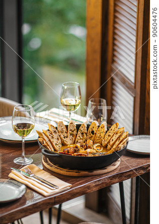 Pan of seafood stew with toasted bread Pan of seafood stew with toasted bread 90604476